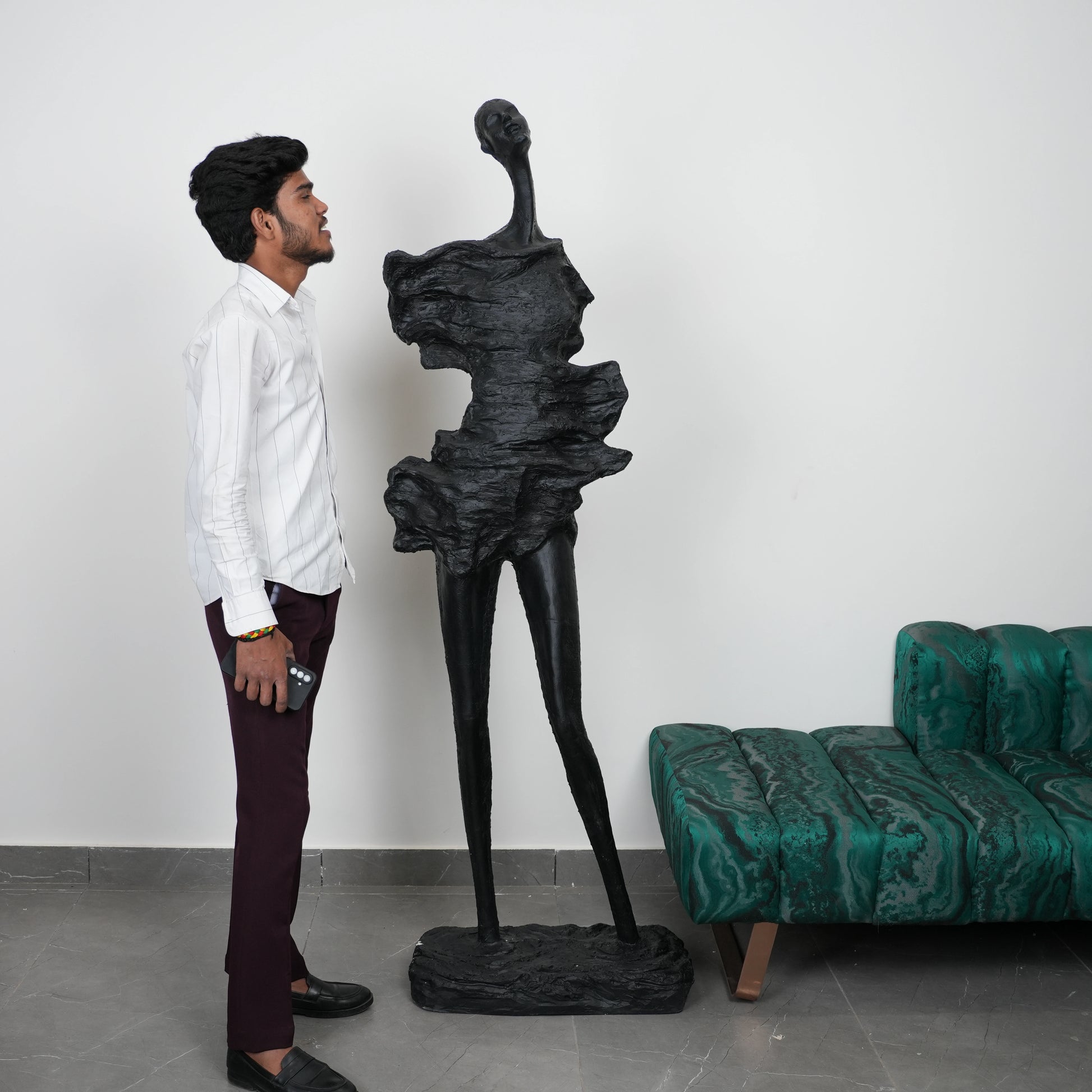 Abstract human sculpt, scale beside man, gallery