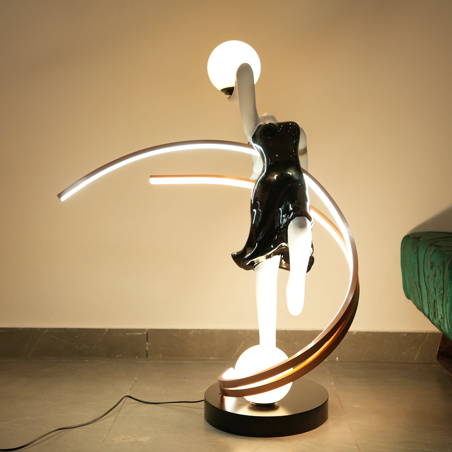 modern human figure lamp with gold orbit and warm LED glow