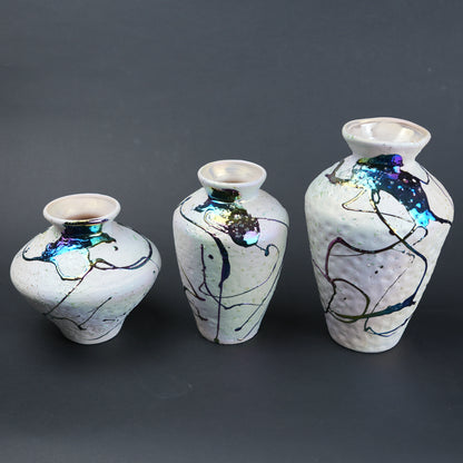 Abstract splash white vase trio on slate