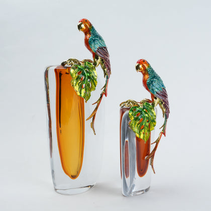 Modern decorative vase with colorful bird design and warm amber glass center