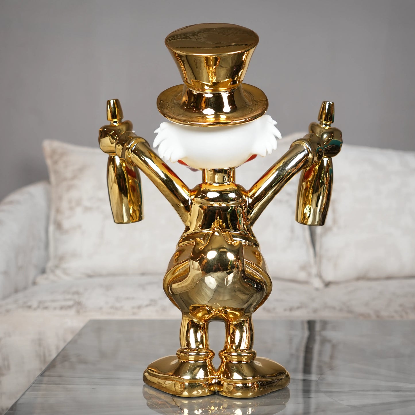 Gold decorative figure on a marble surface with a neutral background