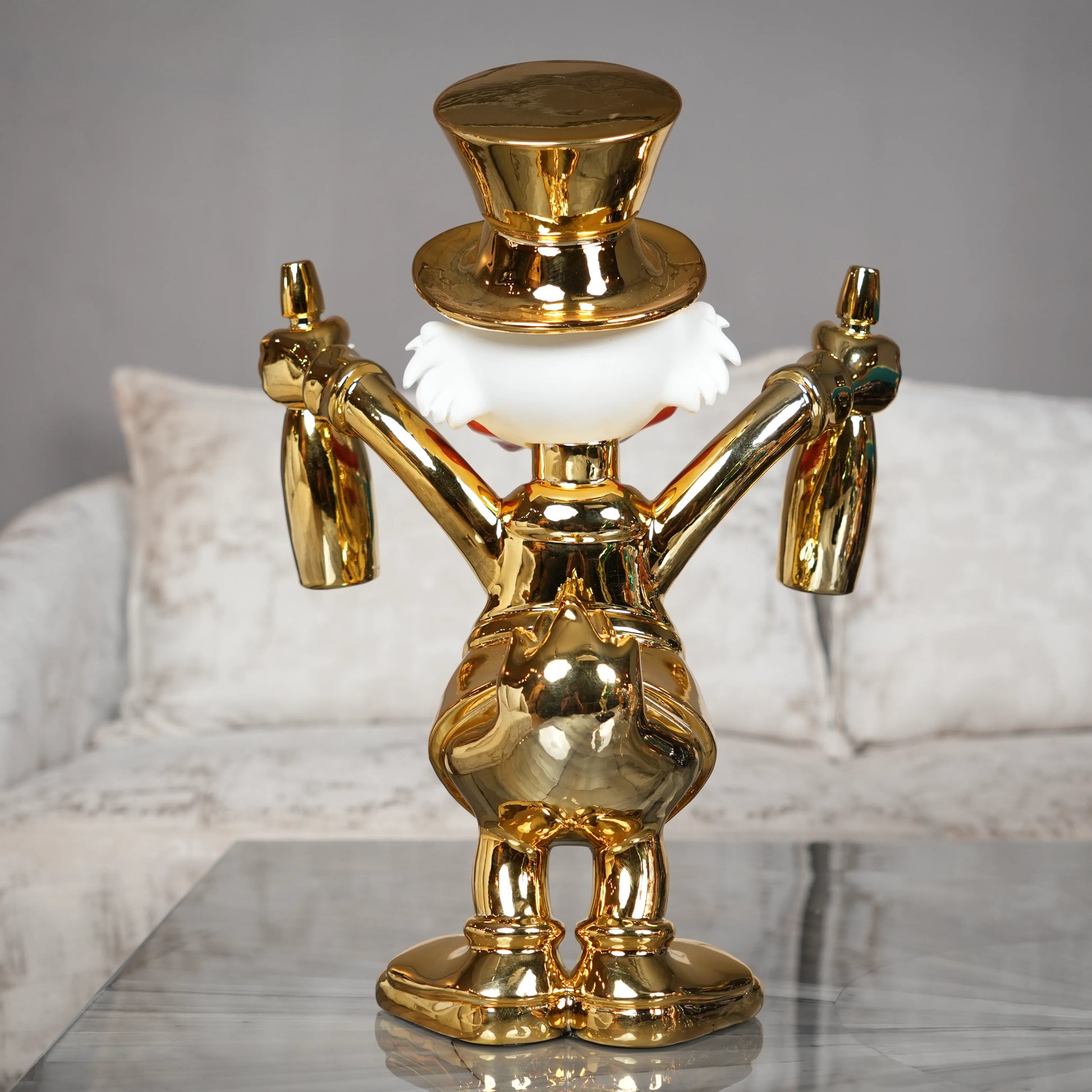 Gold decorative figure on a marble surface with a neutral background