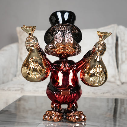 red and gold duck figurine holding money bags luxury decor