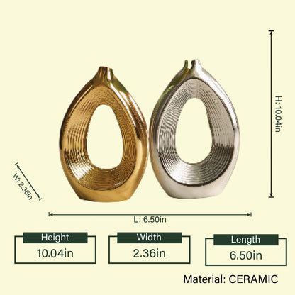Luxury duo set of ceramic vases featuring contemporary hollow oval silhouettes in gold and silver finishes, ideal for fresh flowers, dried botanicals, console tables and modern designer interiors.