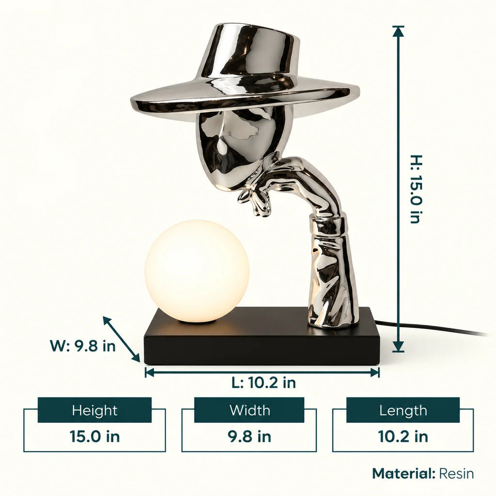 Decorative lamp with a metallic top hat and arm holding a light bulb on a gray background