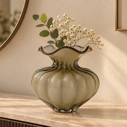 Ribbed glass vase with a smoky beige tint, featuring a rounded bulb shape and a wavy flared rim, designed as a modern decorative piece for home decor styling.