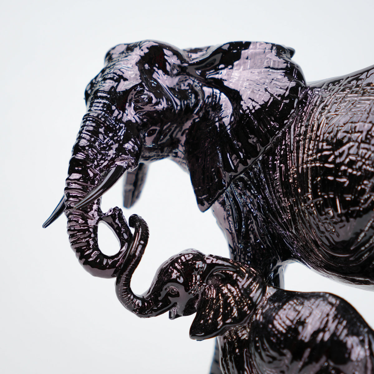 Decorative elephant sculpture with intricate patterns on a white background