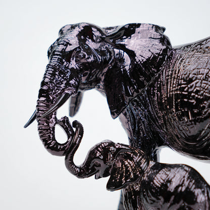 Decorative elephant sculpture with intricate patterns on a white background