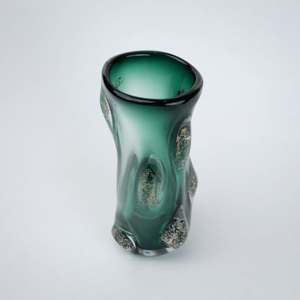 Decorative green glass vase with flared neck and dimensional textured surface featuring subtle shimmer accents in premium finish