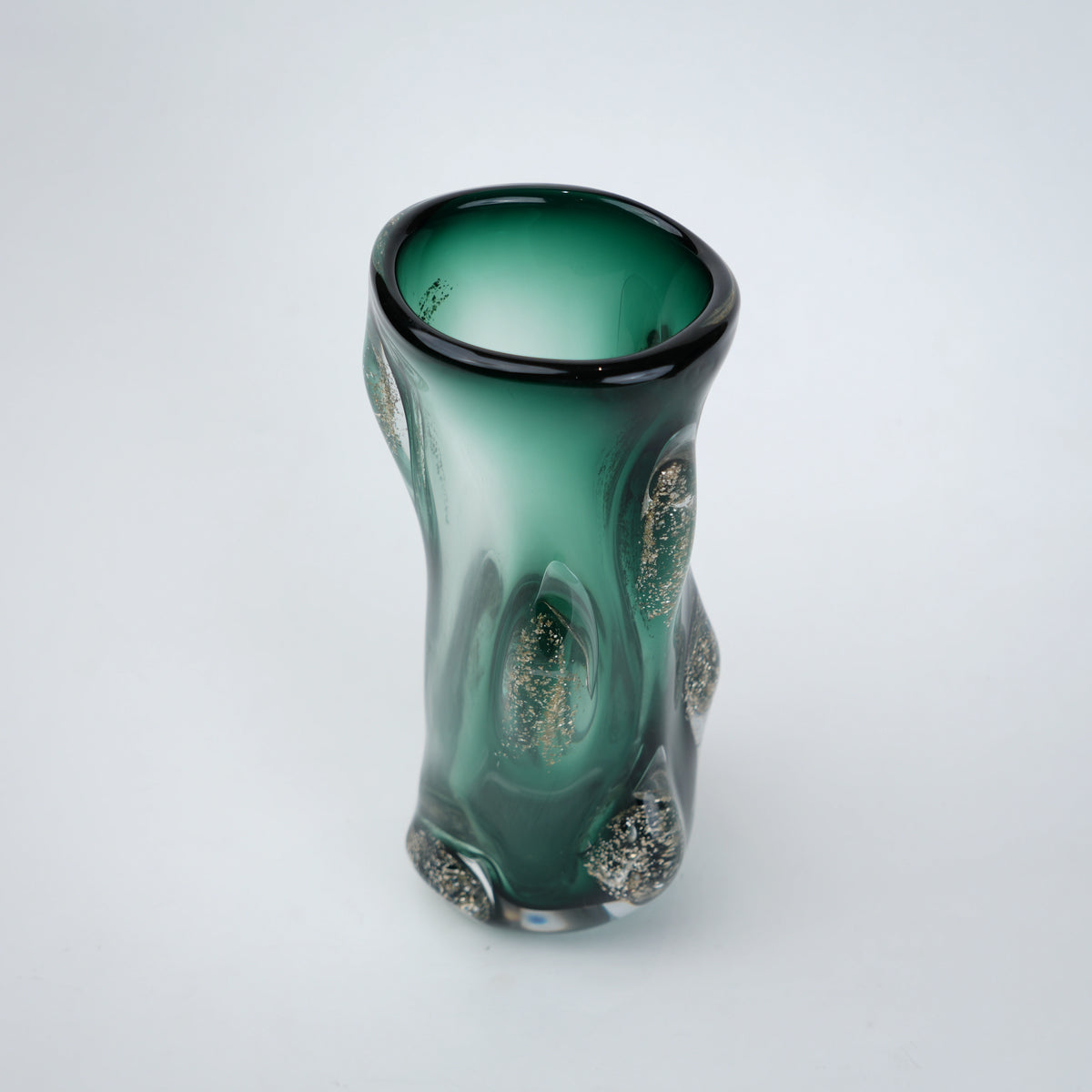 Decorative green glass vase with flared neck and dimensional textured surface featuring subtle shimmer accents in premium finish