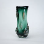Textured green glass vase with sculpted surface and embedded shimmer accents in deep emerald tone with smooth glossy finish