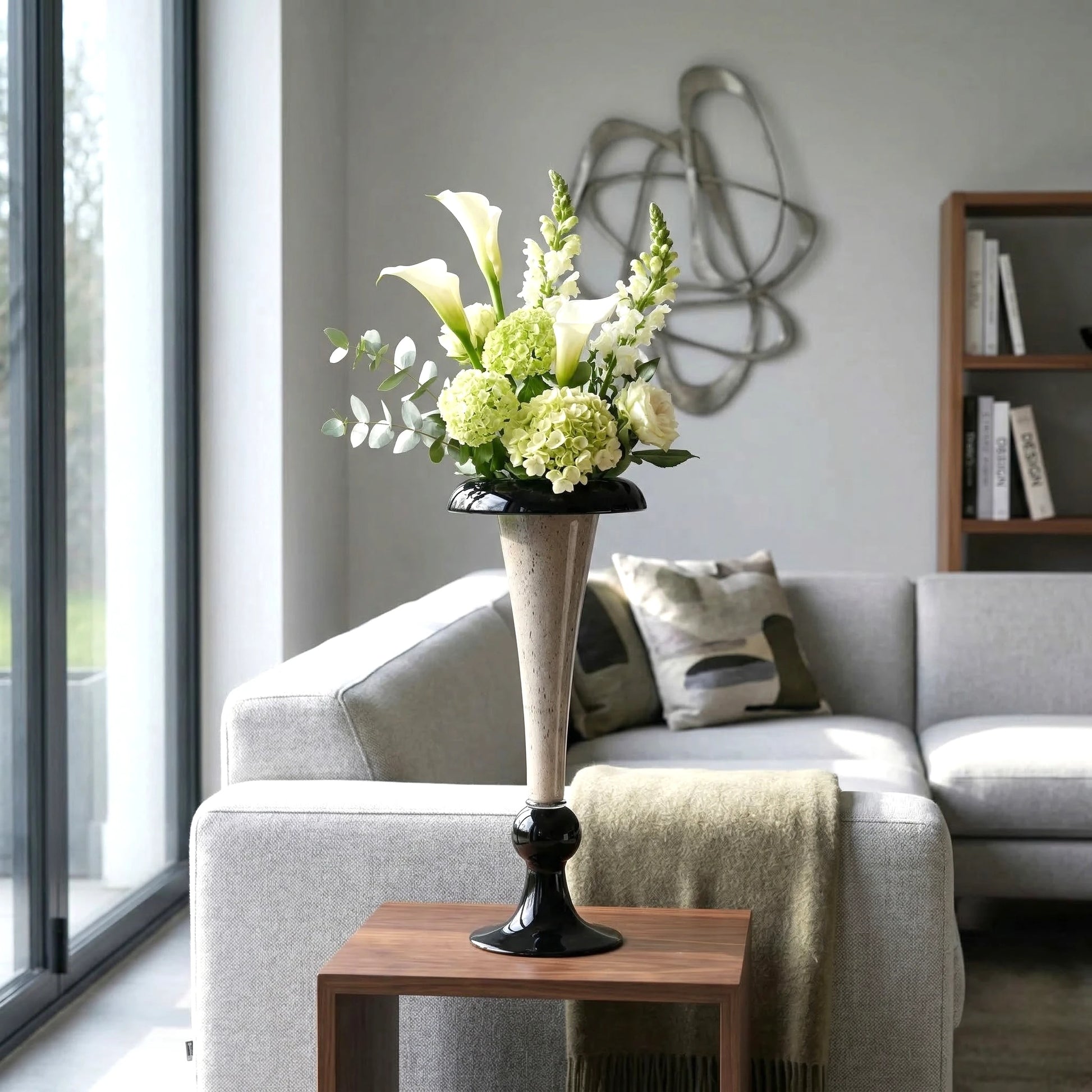 Tall speckle trumpet, calla on walnut table