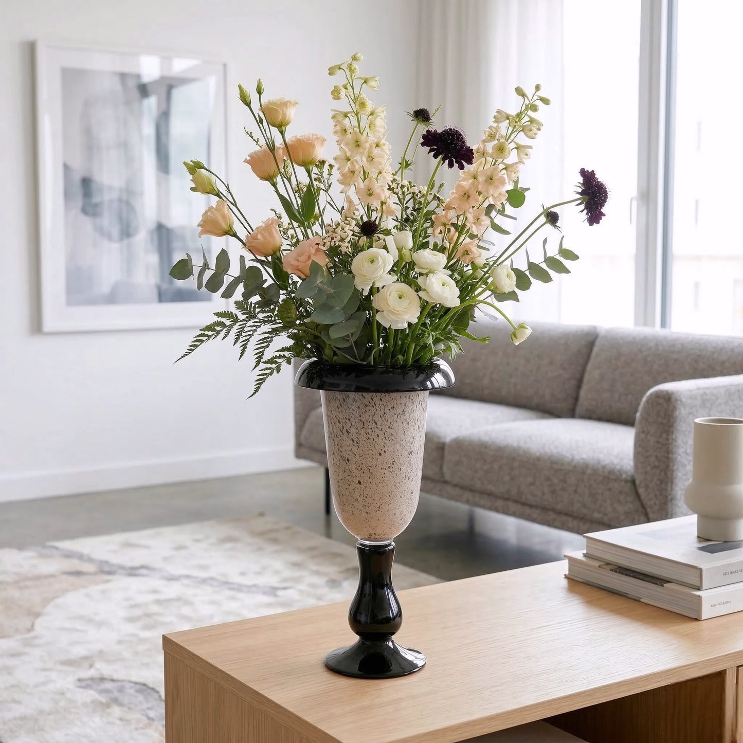 Speckle urn vase, delphinium on oak table