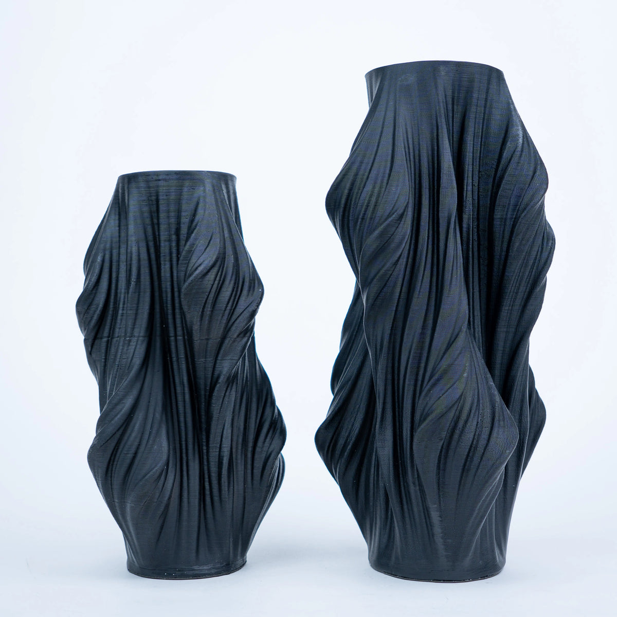 Luxury sculptural resin flower vases featuring flowing artistic textures in matte white and black finishes, ideal for fresh flowers, dried botanicals, console tables and modern designer interiors.`