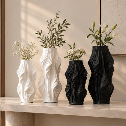 Luxury sculptural resin flower vases featuring flowing artistic textures in matte white and black finishes, ideal for fresh flowers, dried botanicals, console tables and modern designer interiors.`