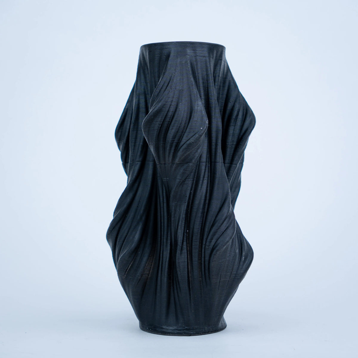 Luxury sculptural resin flower vases featuring flowing artistic textures in matte white and black finishes, ideal for fresh flowers, dried botanicals, console tables and modern designer interiors.`