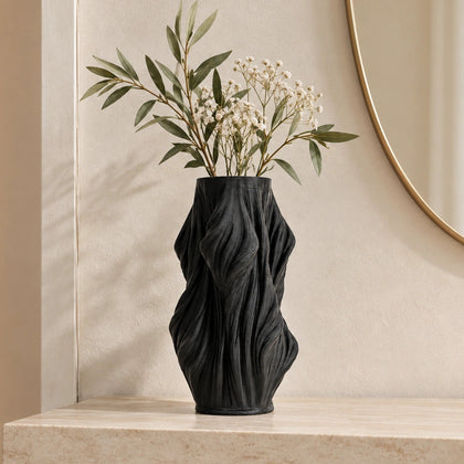 Luxury sculptural resin flower vases featuring flowing artistic textures in matte white and black finishes, ideal for fresh flowers, dried botanicals, console tables and modern designer interiors.`