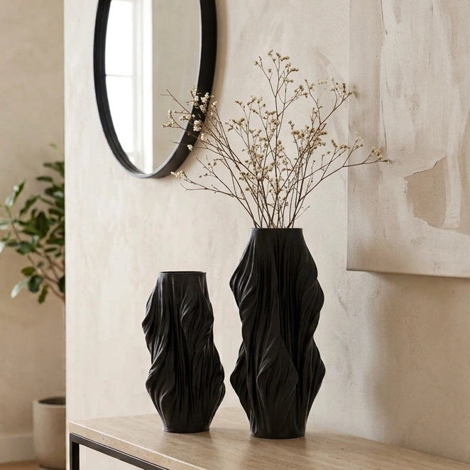 Luxury sculptural resin flower vases featuring flowing artistic textures in matte white and black finishes, ideal for fresh flowers, dried botanicals, console tables and modern designer interiors.`