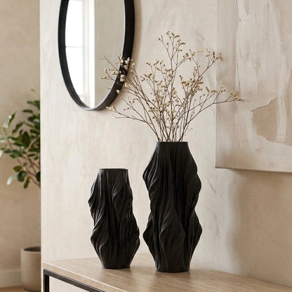 Luxury sculptural resin flower vases featuring flowing artistic textures in matte white and black finishes, ideal for fresh flowers, dried botanicals, console tables and modern designer interiors.`