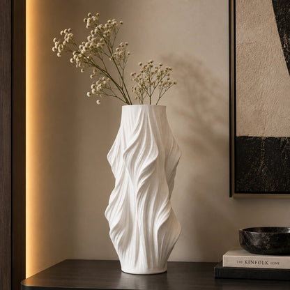 Luxury sculptural resin flower vases featuring flowing artistic textures in matte white and black finishes, ideal for fresh flowers, dried botanicals, console tables and modern designer interiors.`