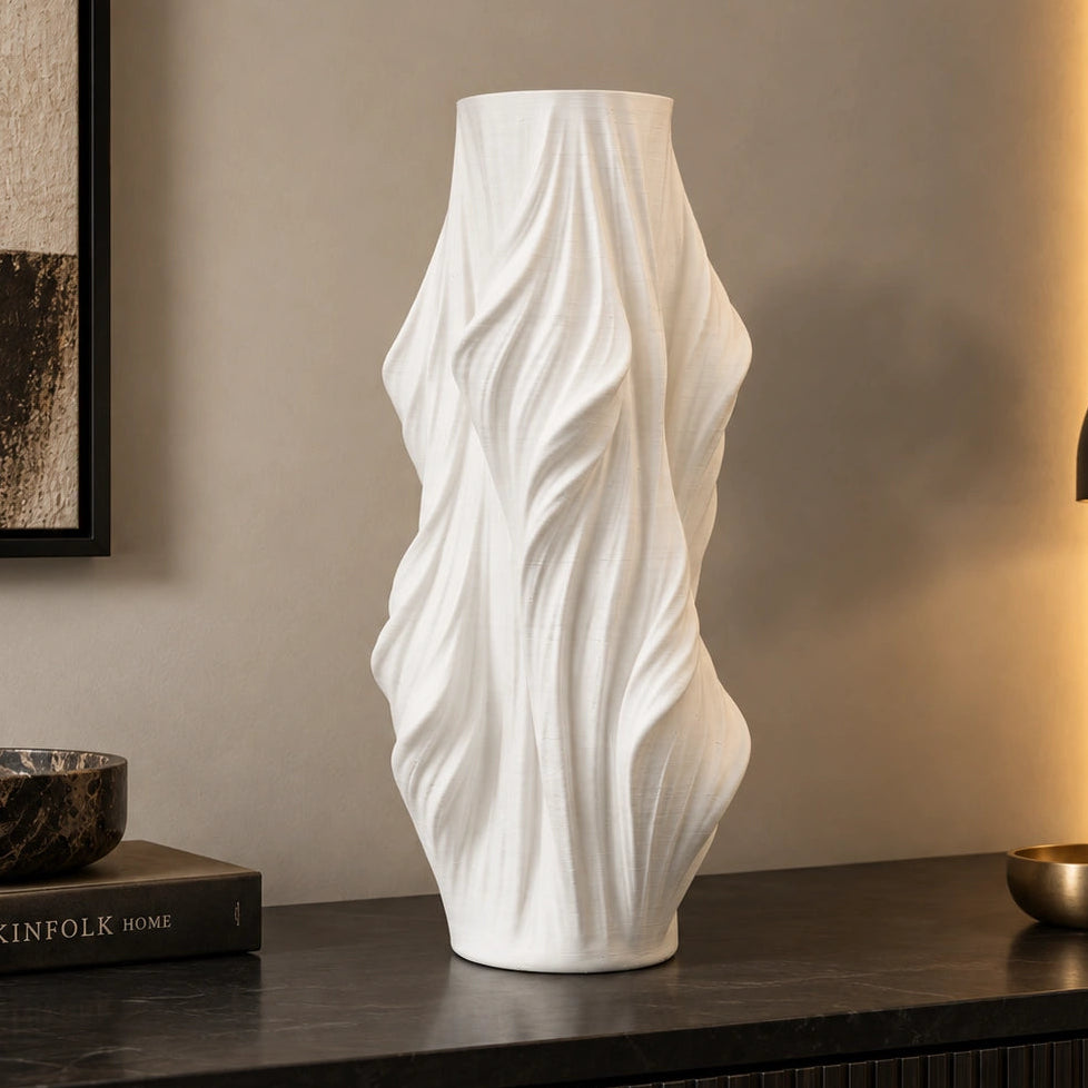 Luxury sculptural resin flower vases featuring flowing artistic textures in matte white and black finishes, ideal for fresh flowers, dried botanicals, console tables and modern designer interiors.`