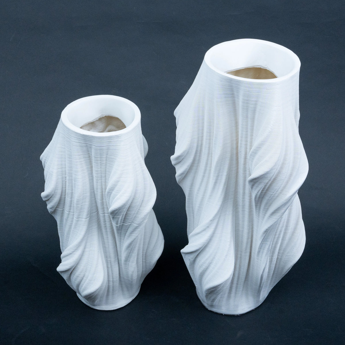 Luxury sculptural resin flower vases featuring flowing artistic textures in matte white and black finishes, ideal for fresh flowers, dried botanicals, console tables and modern designer interiors.`