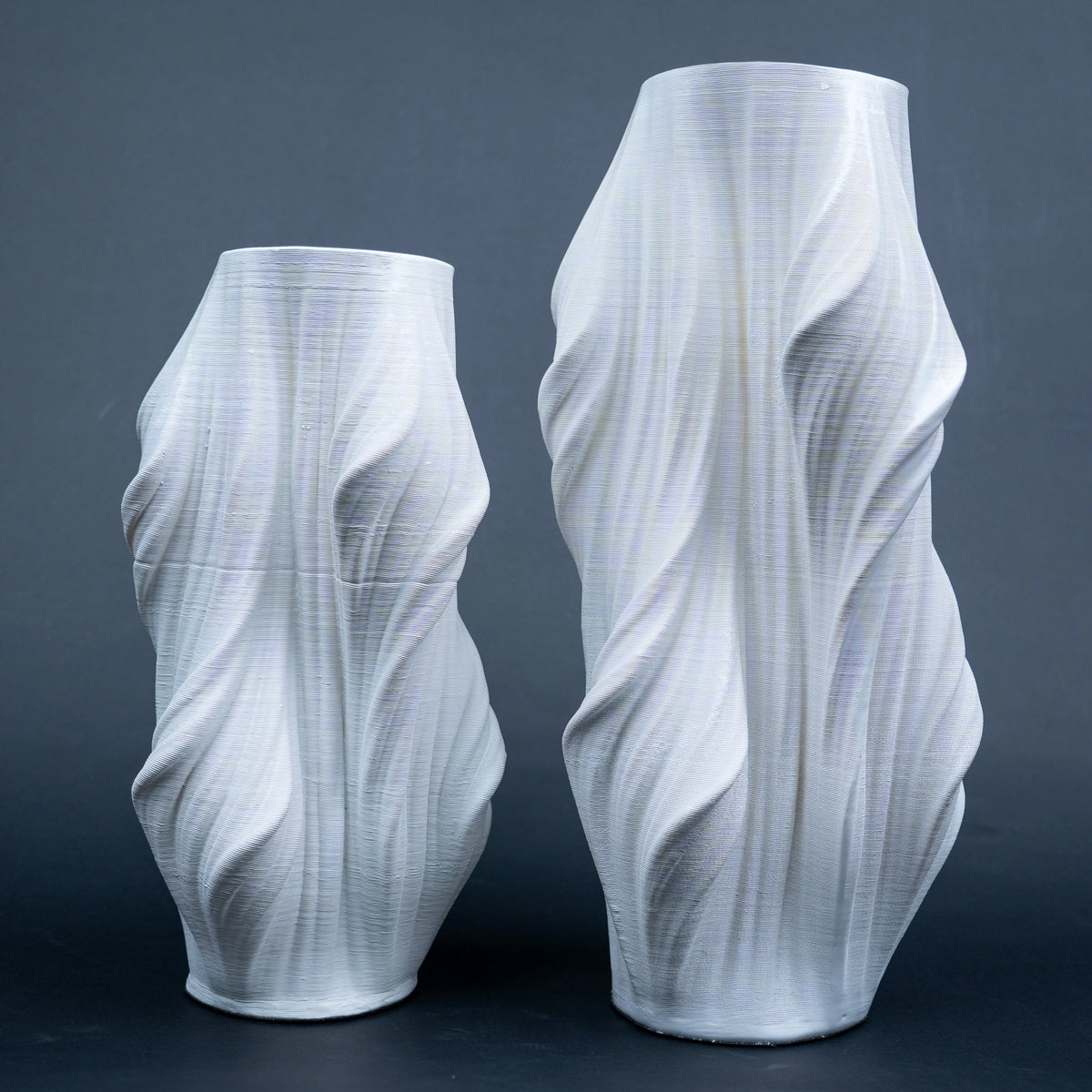 Luxury sculptural resin flower vases featuring flowing artistic textures in matte white and black finishes, ideal for fresh flowers, dried botanicals, console tables and modern designer interiors.`