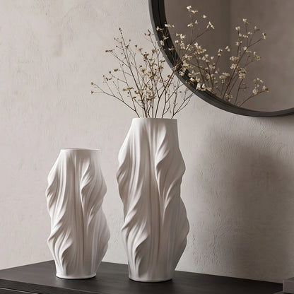 Luxury sculptural resin flower vases featuring flowing artistic textures in matte white and black finishes, ideal for fresh flowers, dried botanicals, console tables and modern designer interiors.`