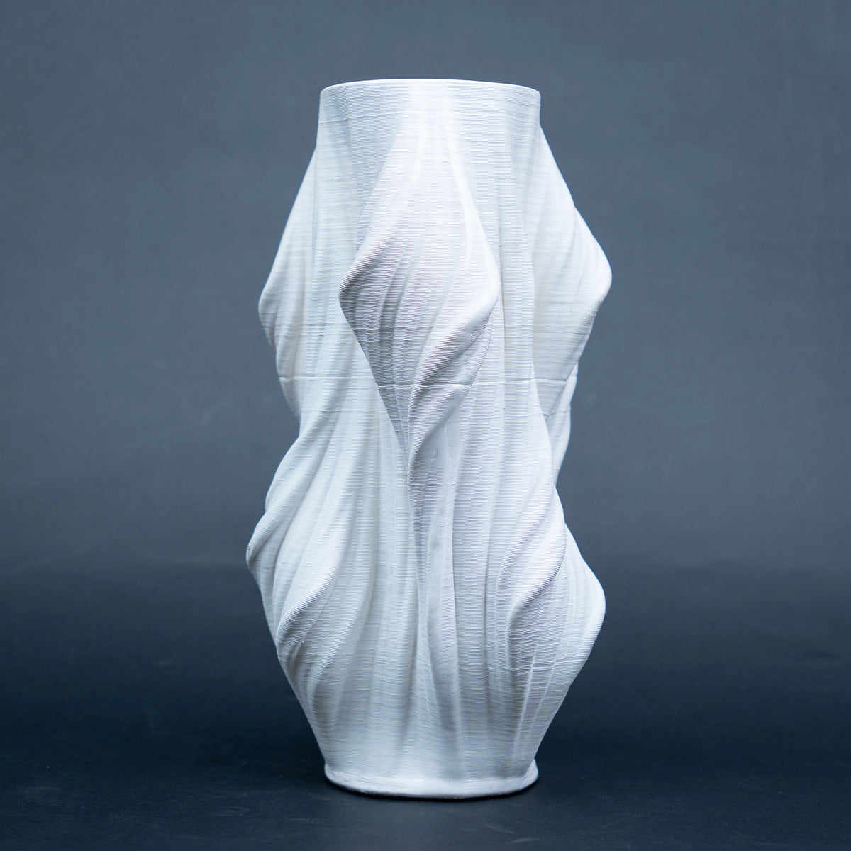 Luxury sculptural resin flower vases featuring flowing artistic textures in matte white and black finishes, ideal for fresh flowers, dried botanicals, console tables and modern designer interiors.`