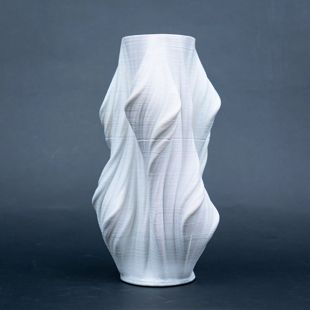 Luxury sculptural resin flower vases featuring flowing artistic textures in matte white and black finishes, ideal for fresh flowers, dried botanicals, console tables and modern designer interiors.`