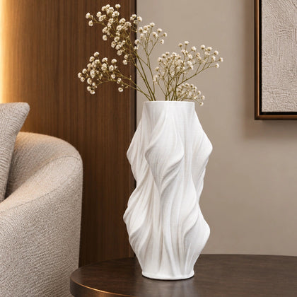 Luxury sculptural resin flower vases featuring flowing artistic textures in matte white and black finishes, ideal for fresh flowers, dried botanicals, console tables and modern designer interiors.`