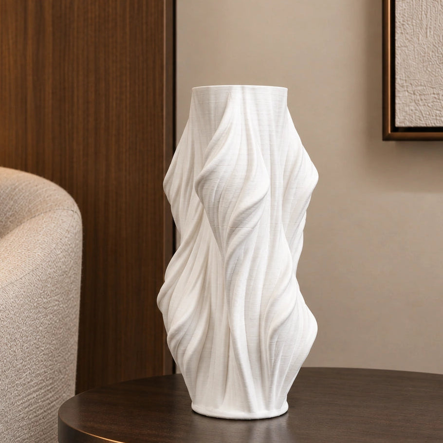 Luxury sculptural resin flower vases featuring flowing artistic textures in matte white and black finishes, ideal for fresh flowers, dried botanicals, console tables and modern designer interiors.`