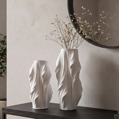 Luxury sculptural resin flower vases featuring flowing artistic textures in matte white and black finishes, ideal for fresh flowers, dried botanicals, console tables and modern designer interiors.`