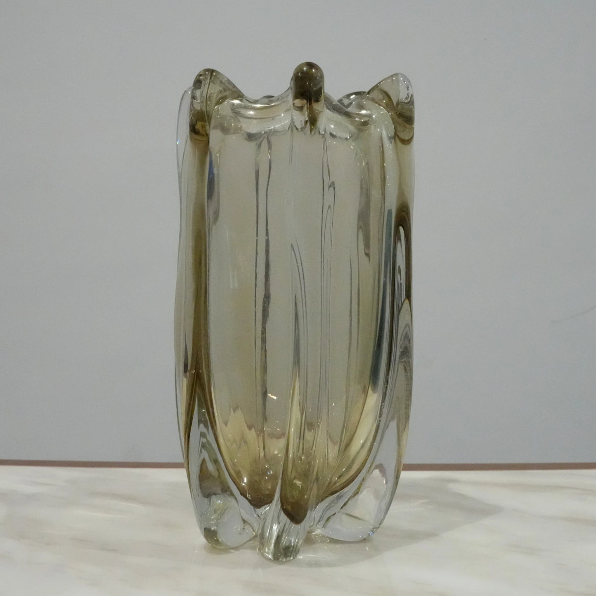 Contemporary art glass vase featuring fluid wave inspired form and handcrafted sculptural detailing for elegant interiors
