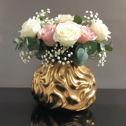 Luxury metallic ceramic decorative vases featuring sculptural fluid textures in gold and silver finishes, ideal for fresh flowers, console tables, dining spaces and modern designer interiors.