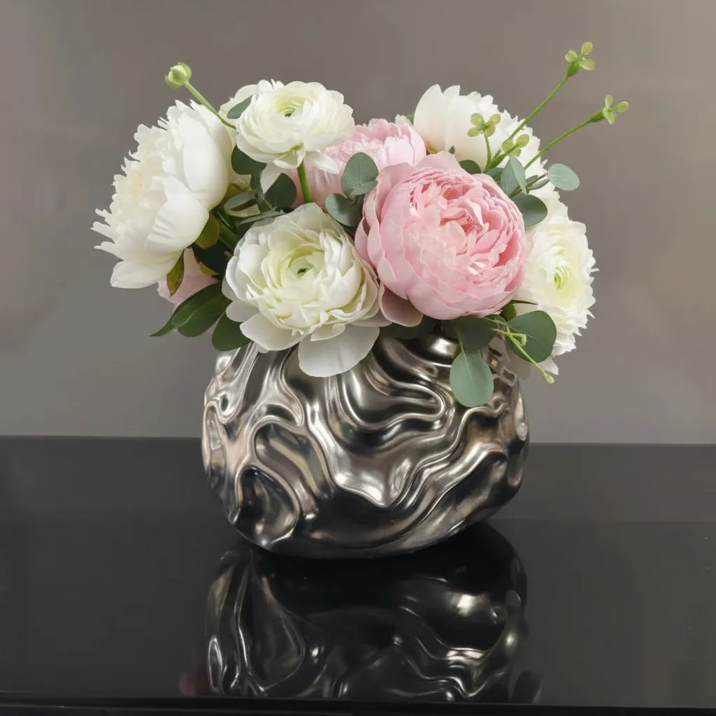 Luxury metallic ceramic decorative vases featuring sculptural fluid textures in gold and silver finishes, ideal for fresh flowers, console tables, dining spaces and modern designer interiors.
