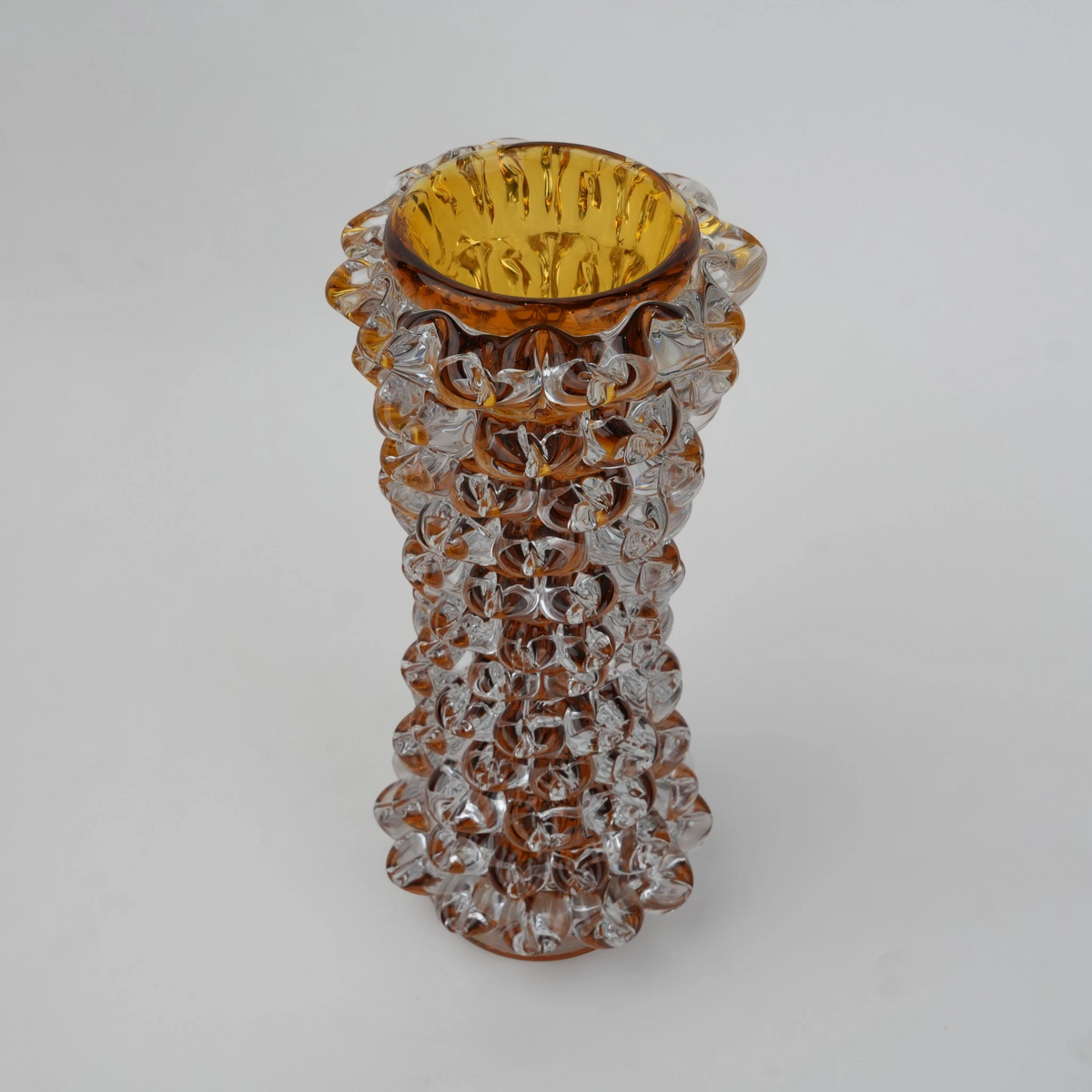 Tall glass vase with a textured distressed finish, featuring a tapered body and narrow neck, designed as a modern decorative piece for home interiors