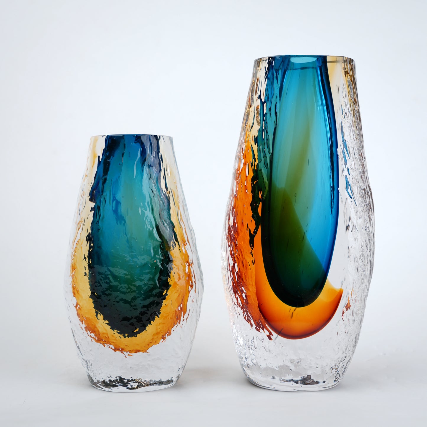 Aqua teal and amber core glass vase with textured clear exterior in two sizes