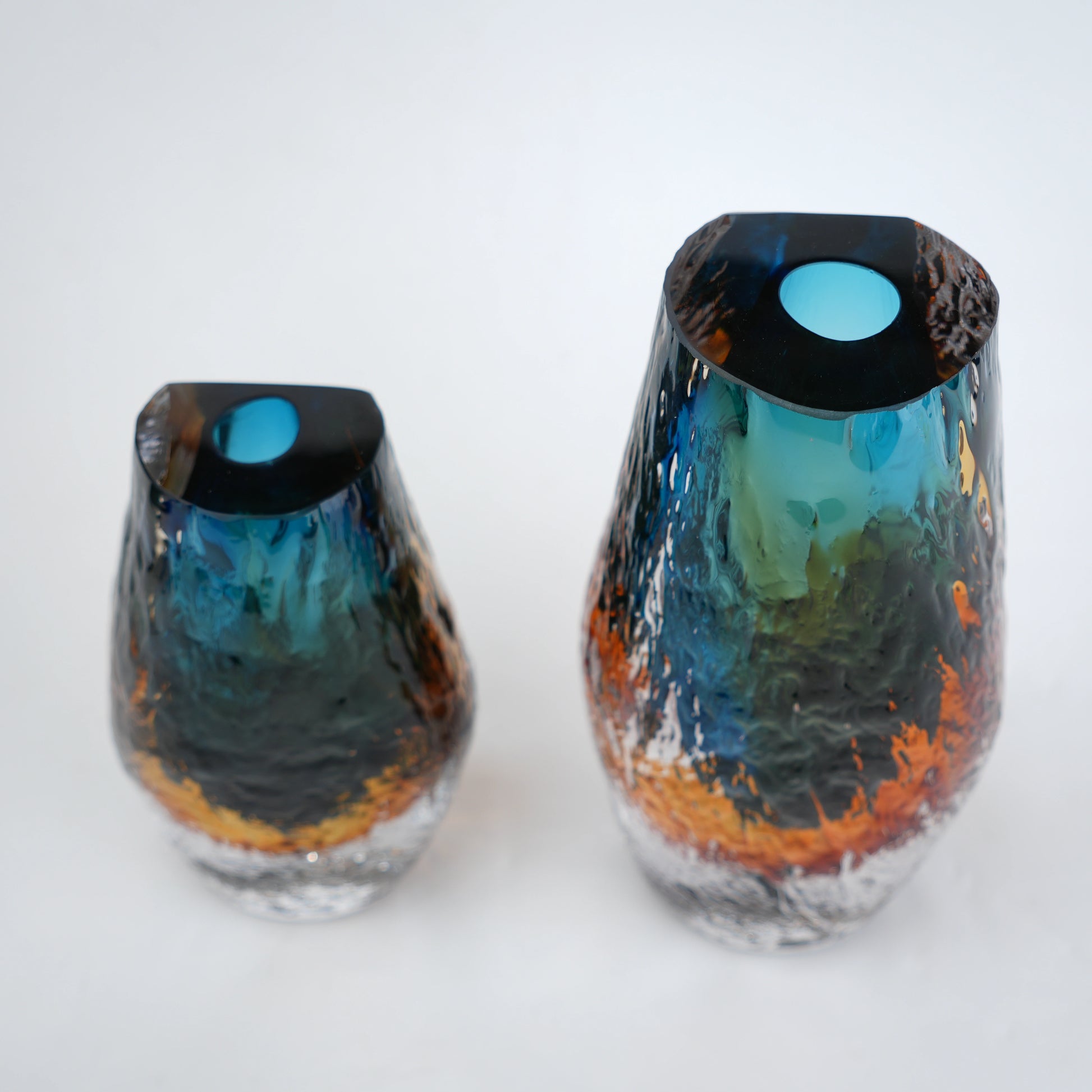 Aqua teal and amber core glass vase with textured clear exterior in two sizes