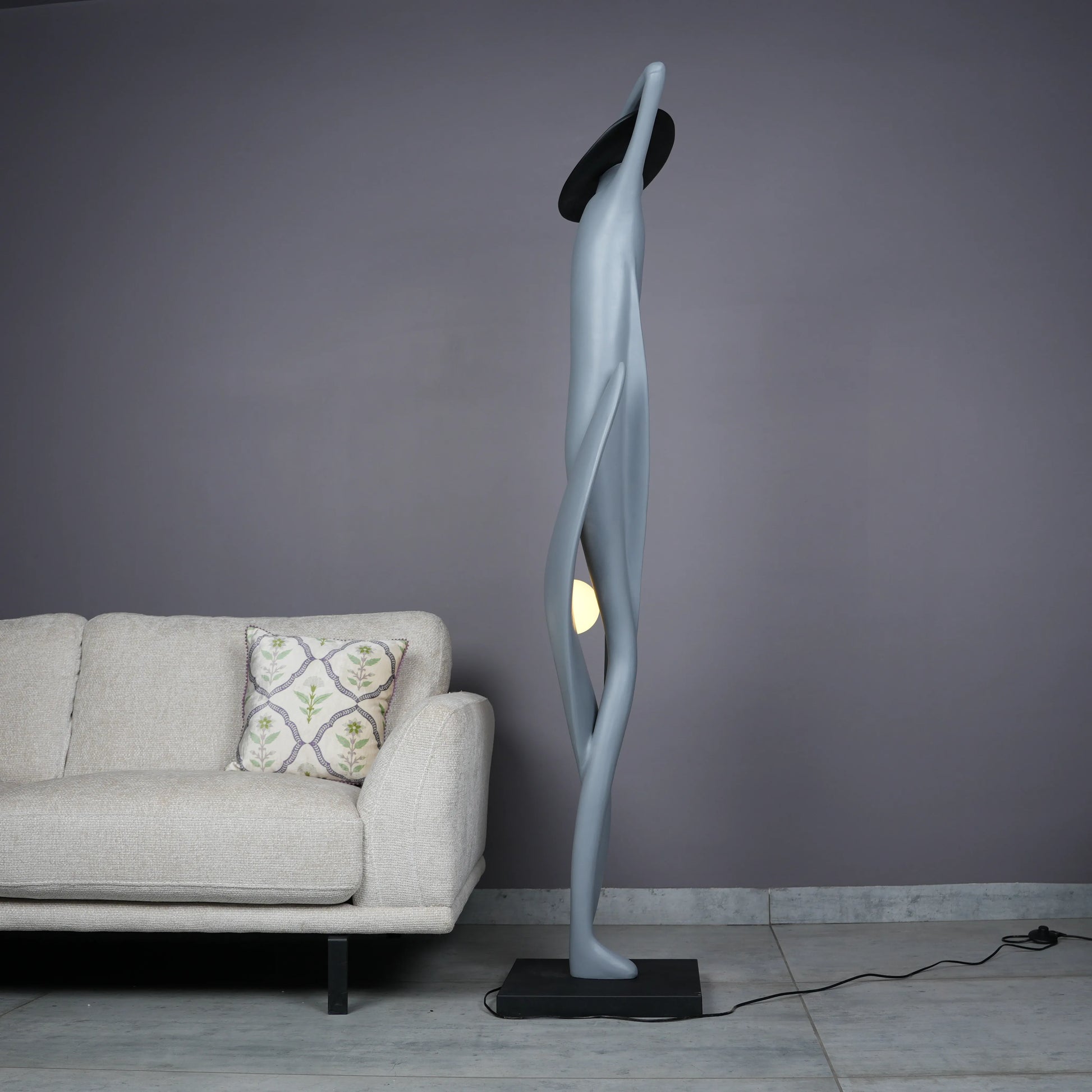 Bluish grey lady sculpture floor lamp with black hat and glowing orb – modern artistic lighting.
