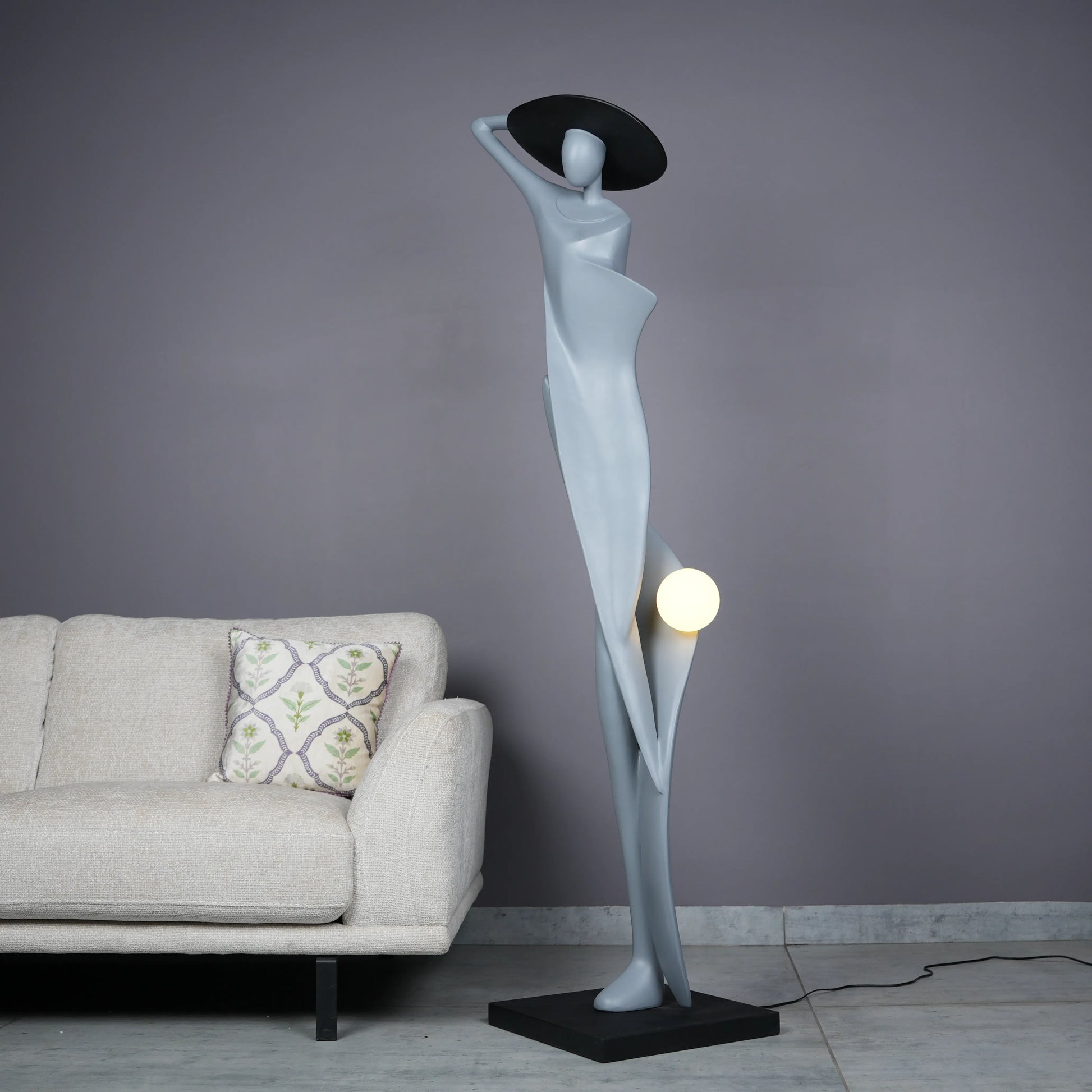 Bluish grey lady sculpture floor lamp with black hat and glowing orb – modern artistic lighting.
