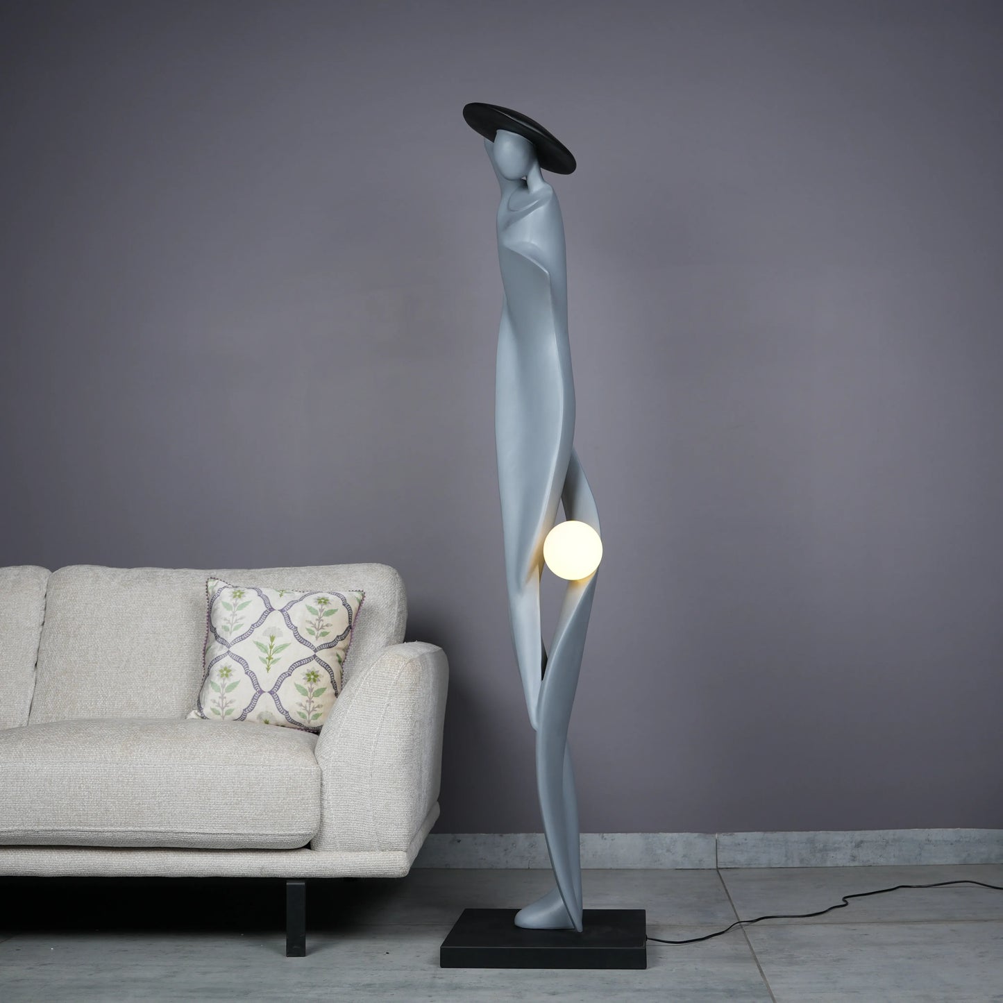 Bluish grey lady sculpture floor lamp with black hat and glowing orb – modern artistic lighting.