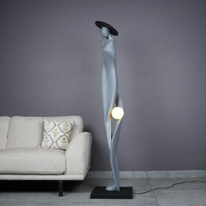 Bluish grey lady sculpture floor lamp with black hat and glowing orb – modern artistic lighting.