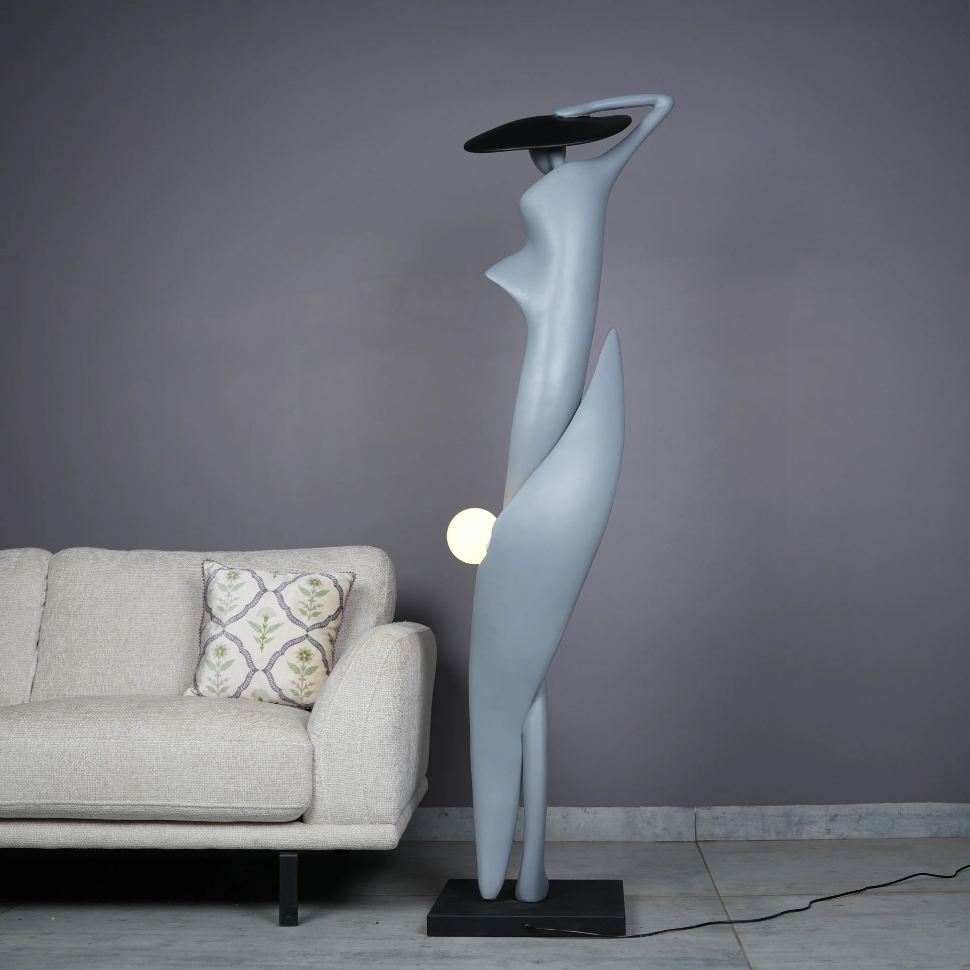 Bluish grey lady sculpture floor lamp with black hat and glowing orb – modern artistic lighting.