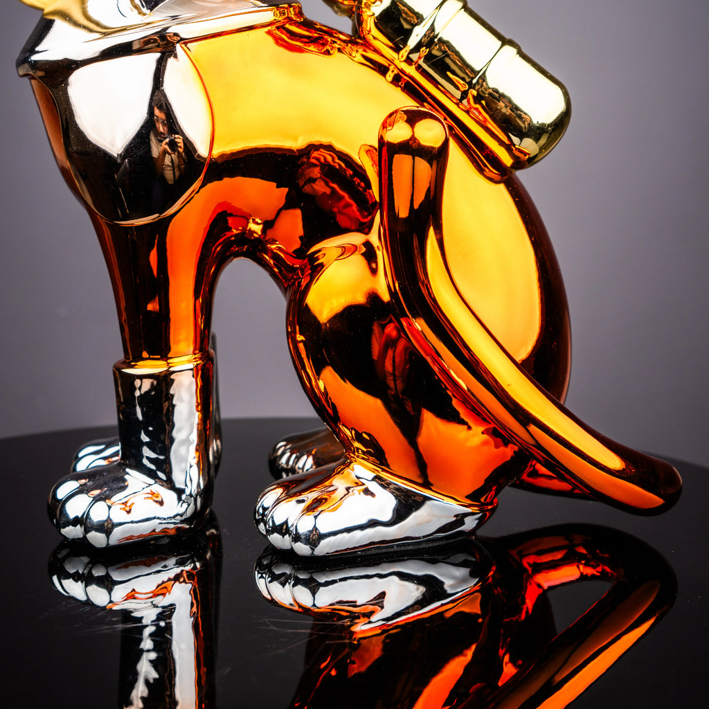 Contemporary cosmic cat figurine with reflective metallic detailing and astronaut helmet design for artistic tabletop decor presentation