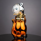 Designer astronaut kitty figurine featuring reflective silver detailing and amber-toned body for playful modern decorative arrangements