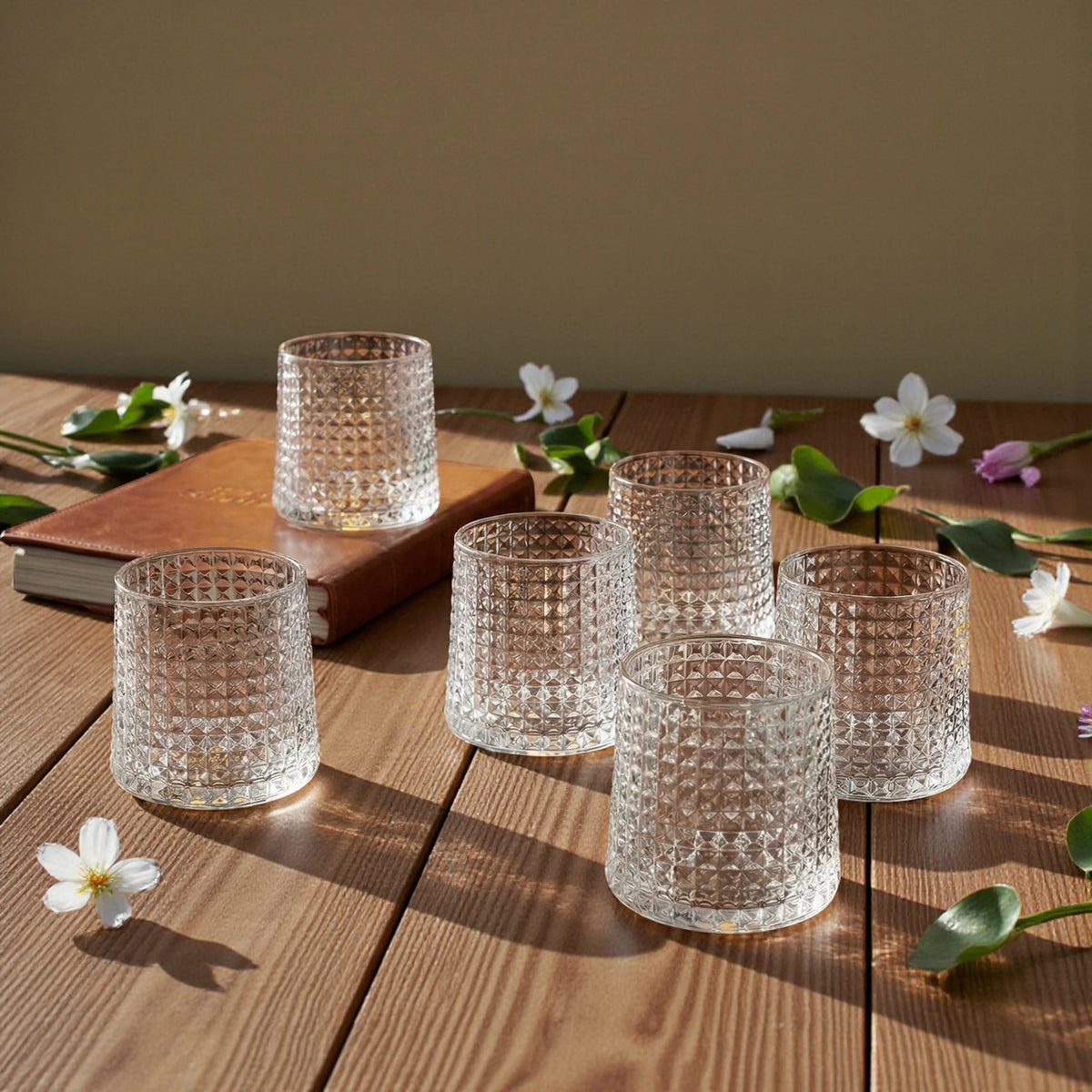 Premium textured whiskey glass set arranged for elegant home entertaining and sophisticated cocktail serving presentation