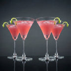 Contemporary martini cocktail glasses arranged on a premium wooden tray in a sophisticated luxury living room entertaining setup
