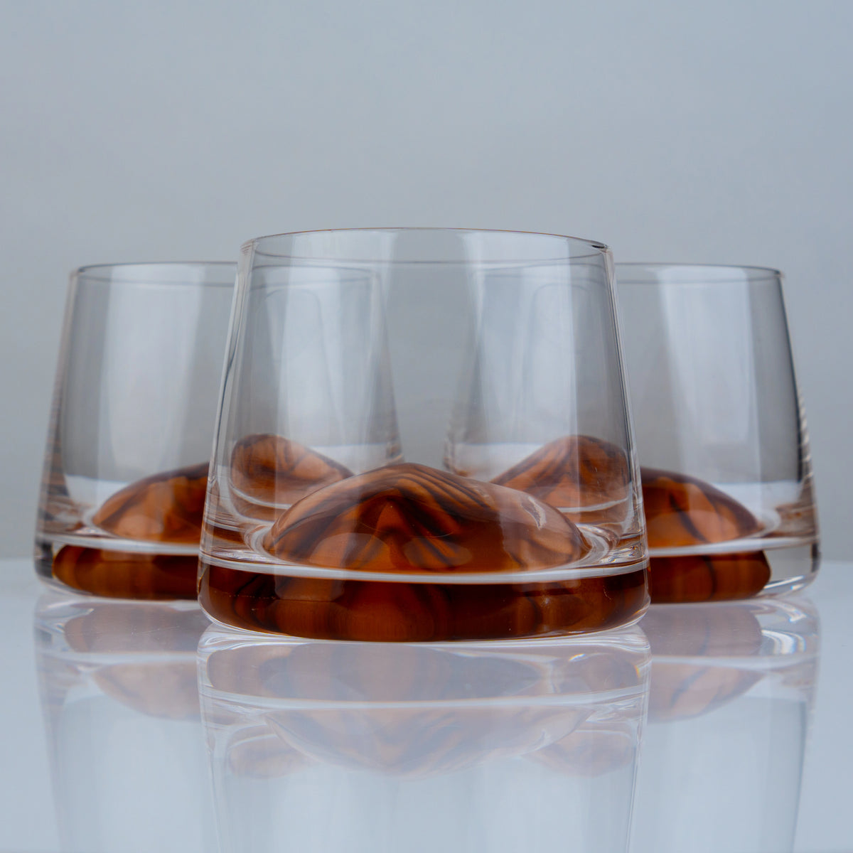 Premium whiskey drinking glasses with elegant amber detailing for sophisticated cocktail serving and contemporary bar styling