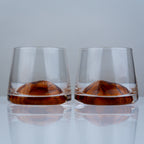Luxury whiskey tumbler glasses with modern transparent finish and amber swirl detailing for elegant entertaining experiences